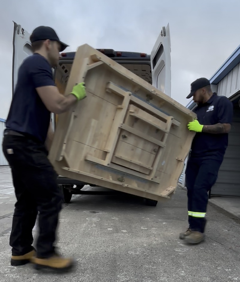 Commercial furniture removal by Direct Junk crew loading large items into truck